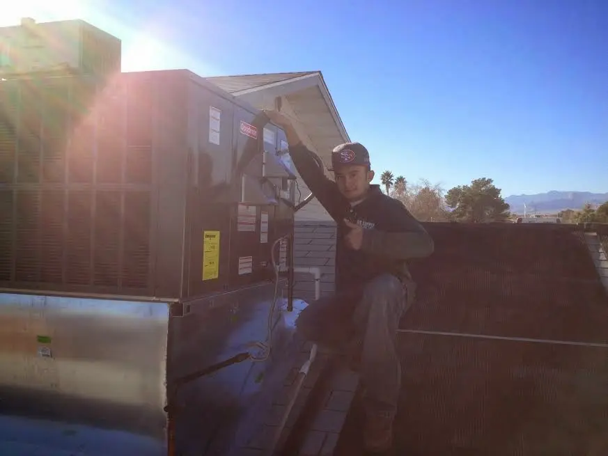 HVAC technician performing Boiler Repair on a rooftop unit in Cranford